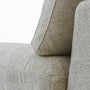 Close-up of the CloudForm™ Middle Armless Modular Sofa in beige, highlighting its textured washable Crypton® fabric, goose down comfort, removable covers, and ModuleSecure™ system at the seat and back cushion seam.