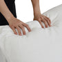 A person presses their hands into the soft, white CloudForm™ 4-Seater Modular L-Sofa, showcasing its plush goose down comfort and textured, washable Crypton® fabric.