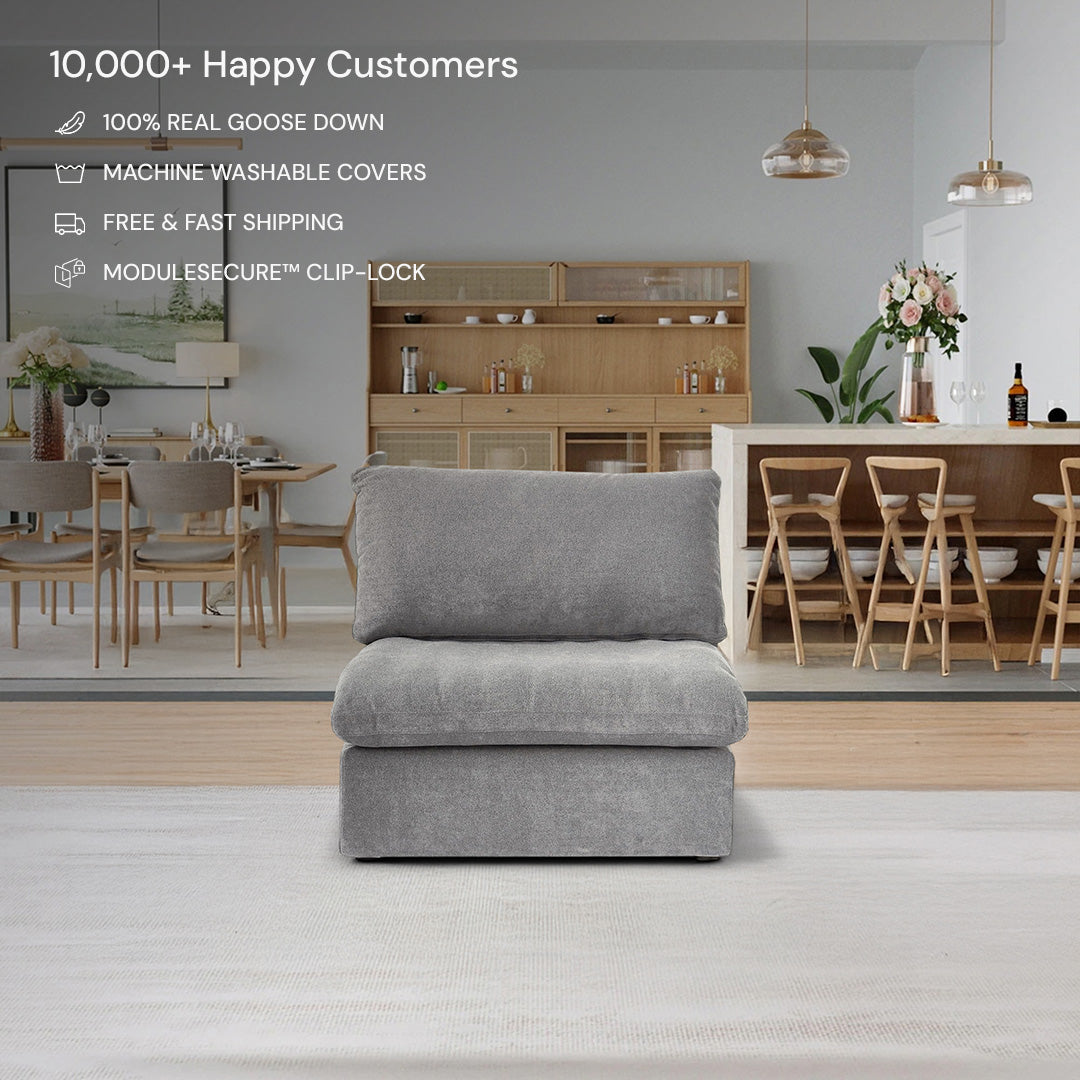 The CloudForm™ Middle Armless Modular Sofa in gray, featuring removable fabric covers, is centered in a modern living and dining area with wooden furniture and floral decor. Product features are displayed above the sofa.
