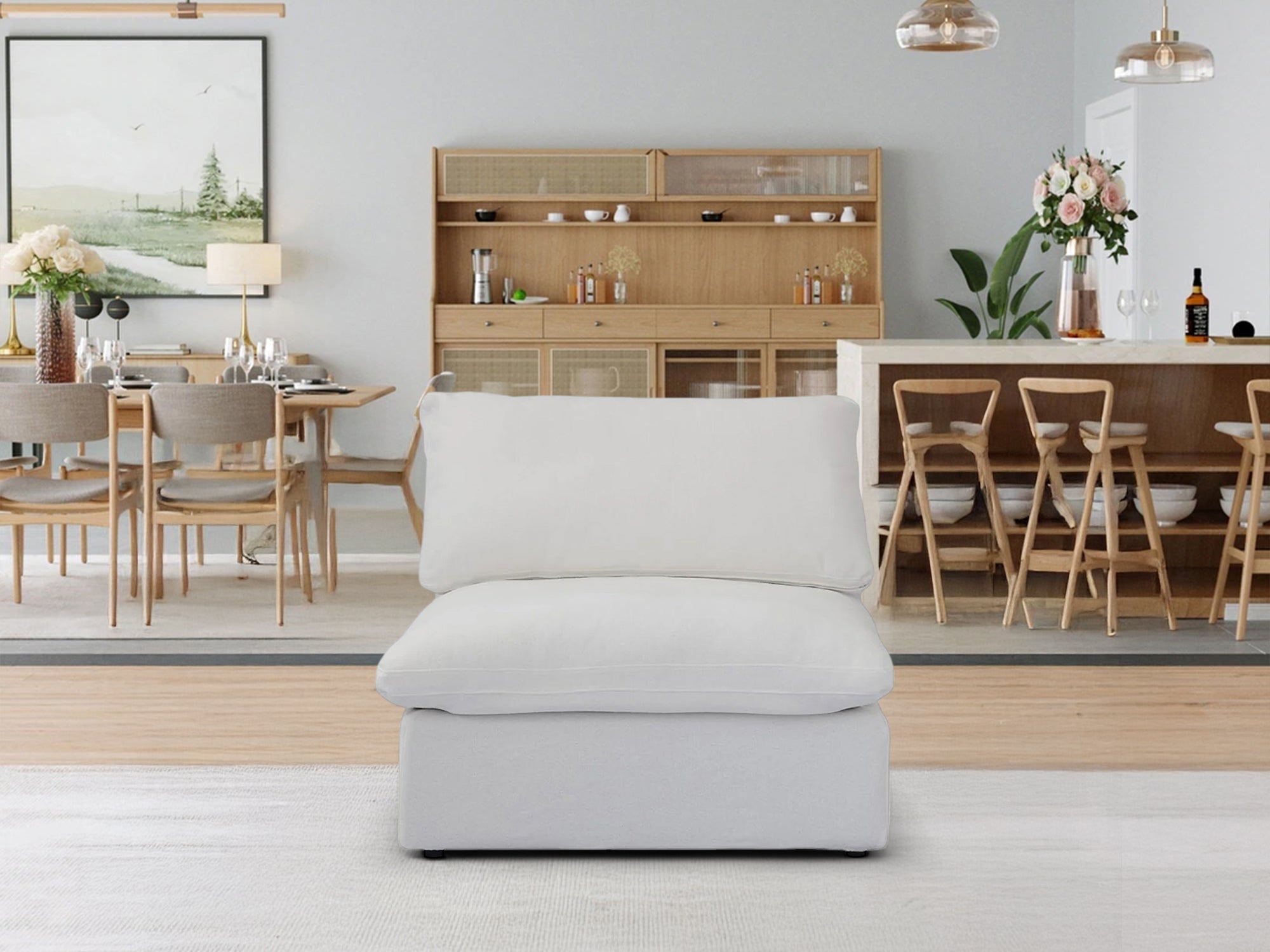 A CloudForm™ Middle Armless Modular Sofa in white, with removable washable Crypton® fabric and goose down comfort, sits on a light rug in a modern dining room with wooden accents and pendant lights.