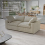 The CloudForm™ 2-Seater Modular Sofa in beige features plush cushions and removable fabric covers, complementing a modern living room with large windows, a dining area, and minimalist decor—earning high customer satisfaction.