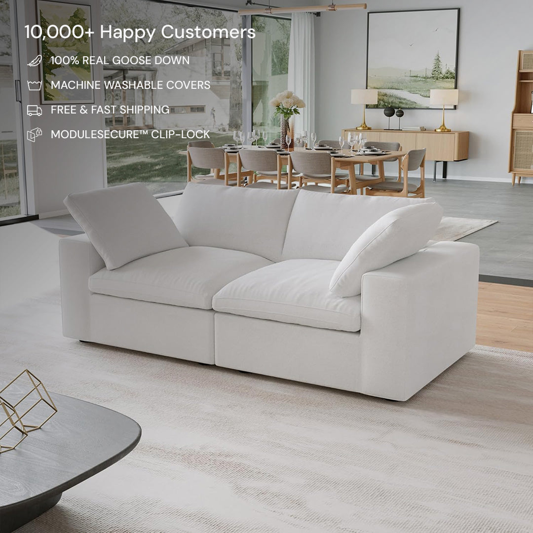 A modern living room with the CloudForm™ 2-Seater Modular Sofa in white, removable fabric covers, a light rug, dining area behind, and large windows. Text highlights sofa features and high customer satisfaction.