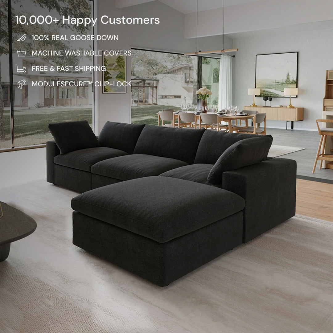 A CloudForm™ 3-Seater + Ottoman Modular Sofa in black sits in a bright, open living and dining space, with key features like removable fabric covers displayed in white text at the top left.