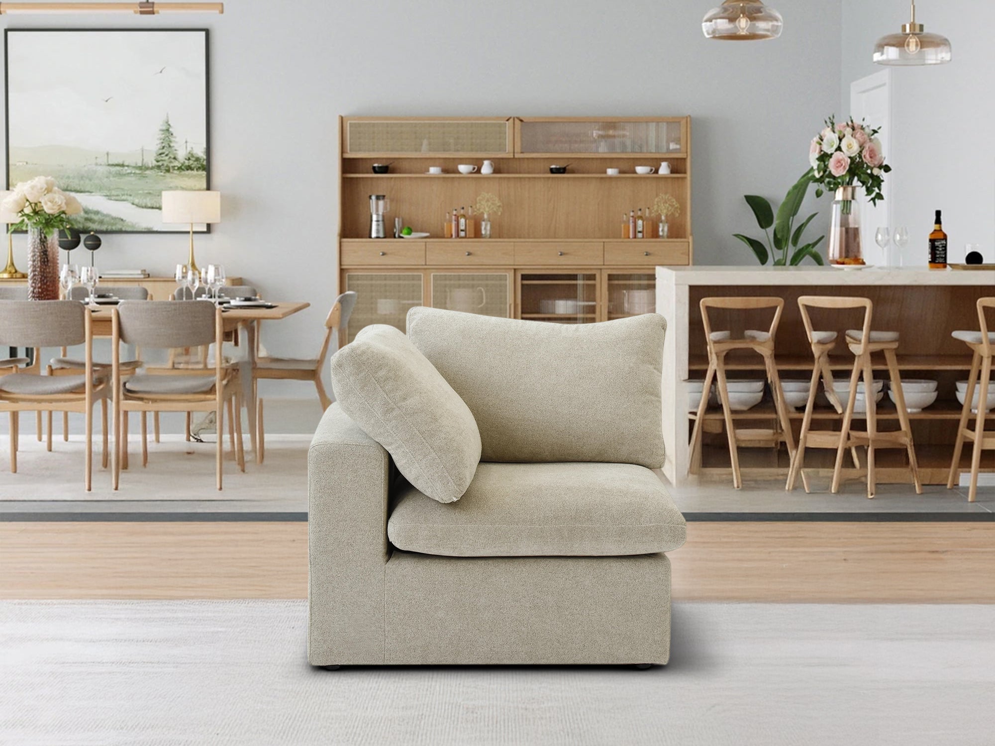 The Sofatica® Corner Cloud Couch in Beige | Premium Version is placed on a light rug in a modern open-plan dining room featuring wooden furniture, pendant lights, and a sideboard decorated with decor items and glassware.