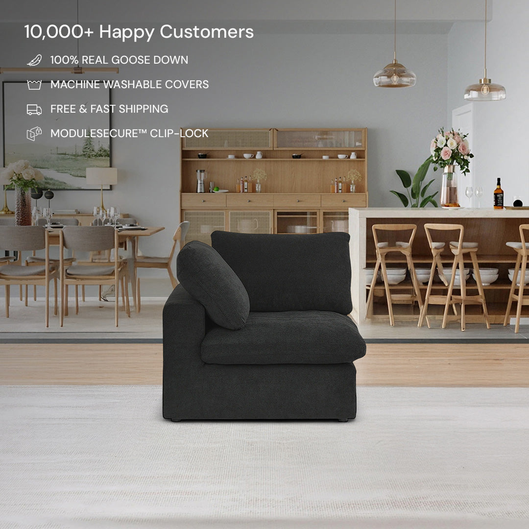 A CloudForm™ Corner Modular Sofa in black with removable covers is the centerpiece of a modern living space featuring wooden dining furniture and neutral decor. Product highlights emphasize comfort, versatility, and customer satisfaction.