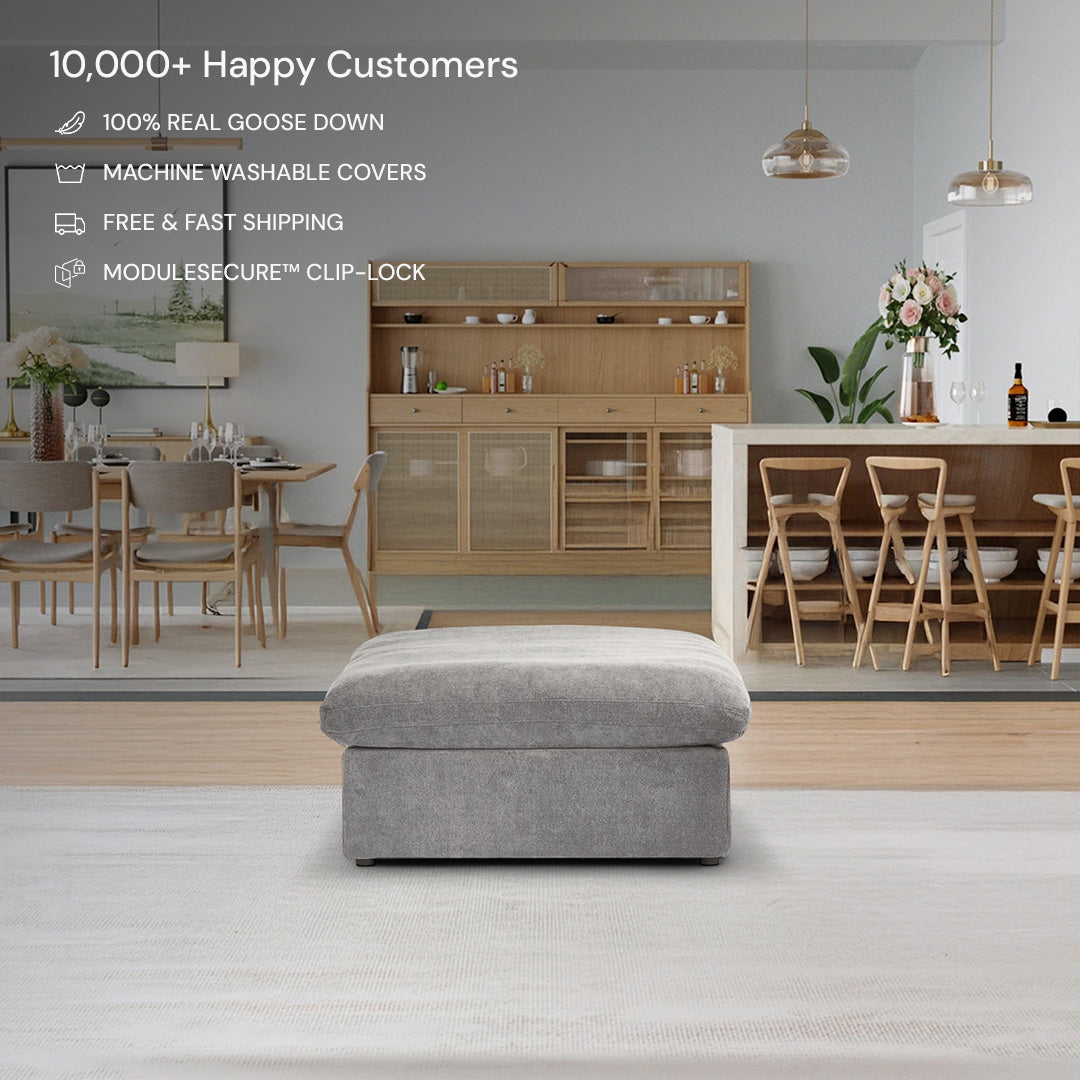 The CloudForm™ Ottoman Modular Sofa in gray, featuring removable fabric covers, is centered in a modern living-dining space with wooden furniture; product features are listed at the top left.